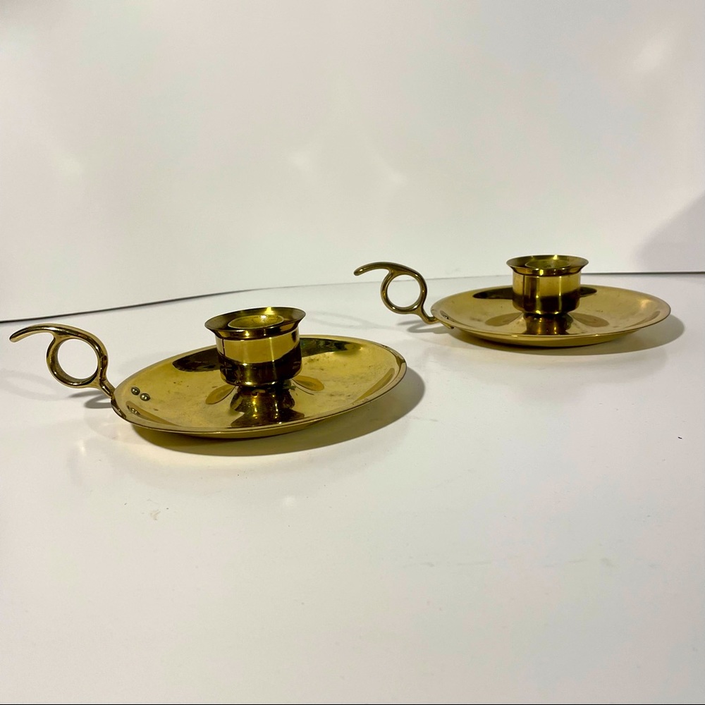 Pair of brass candle holders with carry handles
